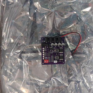 Mini Router UPS Board 40W V2.6 for Router & Modem in Pakistan - a purple circuit board with four DC ports, a red terminal block, and a two-wire connector, resting on plastic.