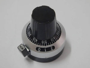 Multi-turn potentiometer knob with dial knob 3590S potentiometer knob with switch lock switch - black and silver circular dial with a locking switch and numbered markings from 0 to 9.