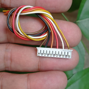 NEMA23 Stepper Motor Connector Flat Pins - shown in a close-up, featuring a white plastic connector housing with multi-coloured wires held in a hand.