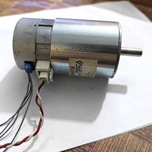Nisca Servo DC Motor With Encoder NF5475E DC 24V To 38V And 3500 To 5000RPM - a cylindrical silver metal motor with a protruding shaft, a white connector, a blue connector, and attached wiring.