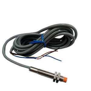 NPN Proximity Sensor - shown as a cylindrical metal threaded sensor with an orange tip, connected to a long grey cable with three exposed wire ends.