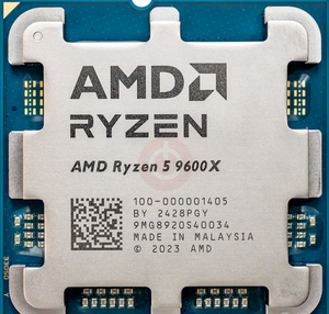 On Demand AMD Ryzen R5 9600X Processor 6 cores and 12 threads - a close-up top-down view of the silver metal integrated heat spreader on a blue square substrate with visible contact pads.