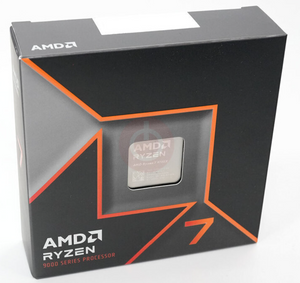On Demand AMD Ryzen R7 9700X Processor 8 cores and 16 threads - shown in its black and orange retail packaging box with a cutout window revealing the metal top of the CPU.