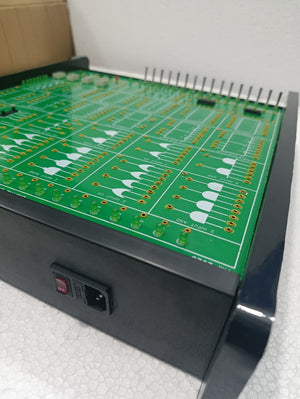 On Demand DLD Trainer Digital Logic Trainer WWW.DIGILOG.PK - a green circuit board with logic gate diagrams, LEDs, and a black power switch on the side.
