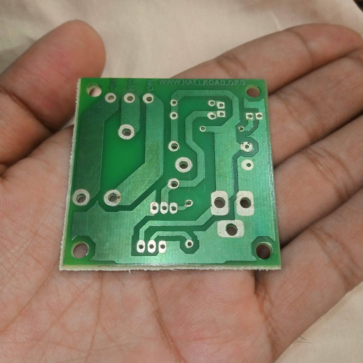 Only PCB For DIY PIR Motion Sensor Switch 5V 30A l Type Relay - shown as a green rectangular printed circuit board with copper traces held in a hand.