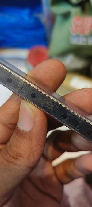 Original Inverter IC DSPIC30F2010 Microcontroller Price - a close-up view of a black integrated circuit chip held in fingers, showing the printed model number and specifications.