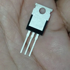 Original IRF540N - IRF540 N-channel MOSFET Transistor TO220 Package - a black and silver three-pin electronic component in a TO220 package held against a person's palm.