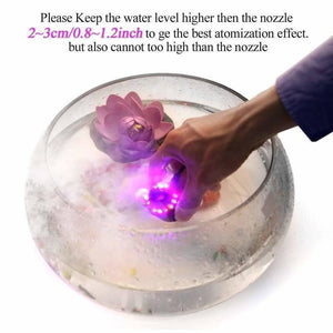 Original Ultrasonic Mist Maker Fogger 12 LED Colorful Light 24V 2A Humidifier - being held in a glass bowl of water with a decorative floating flower.