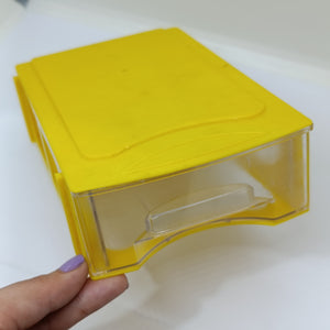 P-106 175MMX108MMX50MM Drawer For Storage Organizer Box - a single yellow plastic storage drawer with a clear front panel held by a hand.