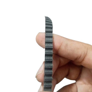 P5M6 1615 timing belt - a close-up view of a black, toothed rubber belt being held vertically between a person's fingers.