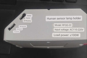PIR Infrared Motion Sensor LED Lamp Wall Mounted Bulb Holder E27 AC220V - a white housing with two adjustment sliders and printed specifications.