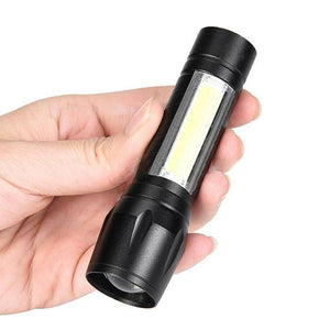 Portable Mini Telescopic Zoom Xpe COB LED Main Light White Light - a black handheld flashlight with a rectangular COB light strip on its side.