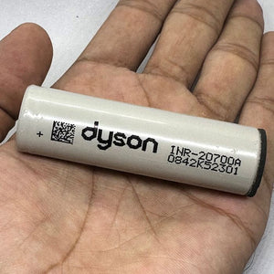 Pull-out Original Lithium Ion Cell 3.7V 3000mAh Li Ion Battery Cell INR-20700A - a cylindrical white battery held in a hand with Dyson branding printed.