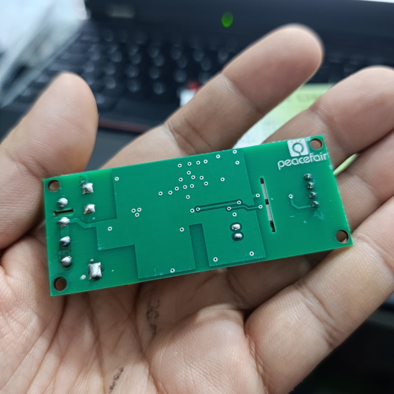 PZEM-004T 100A Single Phase Power Energy Meter Module - shown from the back, featuring a green rectangular PCB with visible solder points and connectors.