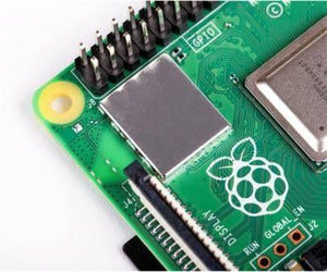 Raspberry Pi 4 2GB RAM - the green circuit board, a metallic shielding cover, the Raspberry Pi logo, a display connector, and pin headers.