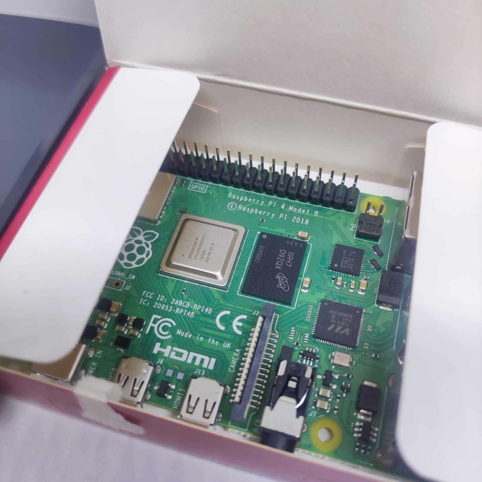 Raspberry Pi 4 4GB RAM Starter Kit - the green circuit board inside its white packaging, featuring visible GPIO pins, HDMI ports, and camera connector.