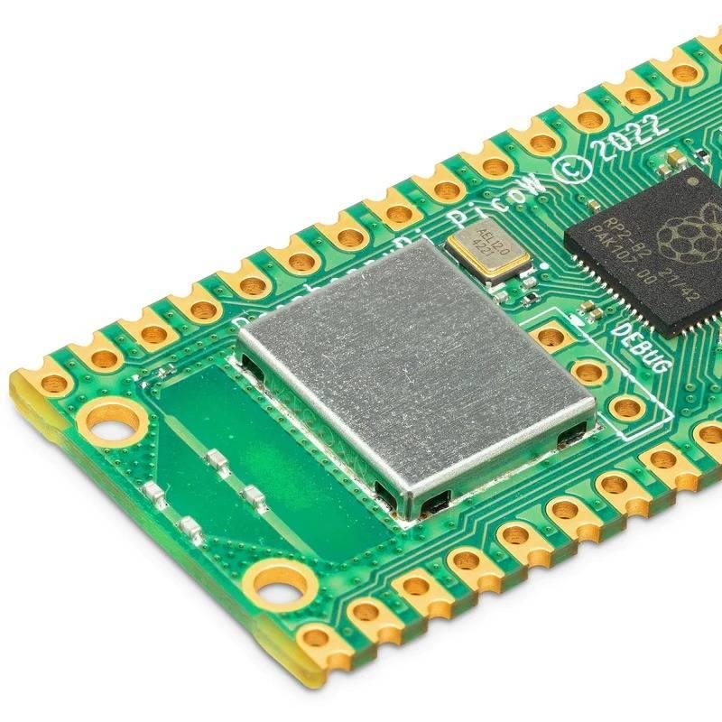 Raspberry Pi Pico w - a close-up view of the green circuit board showing the RP2040 chip, metal-shielded wireless module, and gold-plated pin headers.