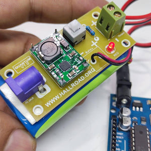 Rechargeable Battery Pack For Arduino And Robot Power Supply With Charger - a green circuit board with a purple DC jack, button, and red LED.