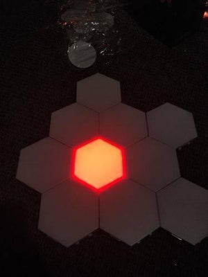 Red Touch Light Wall Mount Magnetic Modular (1pc) - a single red illuminated hexagonal light panel surrounded by six unlit white hexagonal panels.