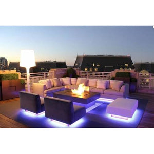 RGB LED Strip 30 LED Per Meter 5 Meter Roll 5050 Size 12V - 12V installed under outdoor patio furniture, emitting a bright purple glow on the floor.
