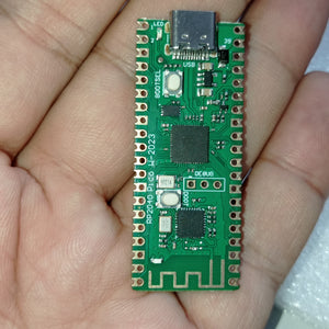 RP2040 Raspberry Pi Pico W Board with 2.4G WiFi Micro Dual-Core 264KB ARM Microcomputers High-Performance Cortex-M0 Processor - a green rectangular microcontroller with a USB-C port, two buttons, and a printed antenna, held in a person's hand.