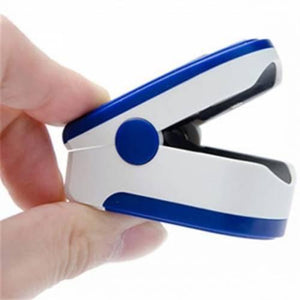 SPO2 Pulse Oximeter With Heart Rate Monitor - shown in white and blue, held open by a hand to reveal the internal finger chamber and side hinge button.