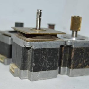 Stock Lot Used Bipolar NEMA 23 Stepper Motor Lot - three silver and black square stepper motors with metal shafts and white electrical connectors.