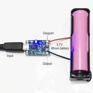 TP4056 1A Li-ion Battery Charging Board Micro USB With Current Protection BMS - blue PCB, micro USB port, and red and black wires connected to a 3.7V lithium battery in a holder.
