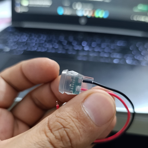Type-C 2P Round Transparent Green Light USB Female Port – LED Plug-in Type - the clear plastic casing, internal green circuit board, and two wires.