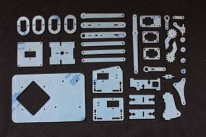 Unassembled 4dof Robotic Arm - a flat-lay of white laser-cut acrylic structural parts and mechanical components on a black background.