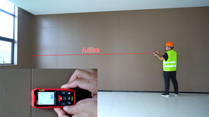 UNI-T laser distance meter measuring a large room with a visible red laser beam