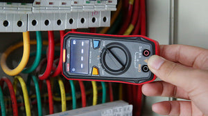 UNI-T UT123 Pocket Residential Digital Multimeter – EBTN Display, AC/DC Voltage, Resistance, Temperature, NCV, Diode & Continuity, One-Hand Design - held in a hand near electrical wires, showing a black and red body, rotary dial, and NCV display.