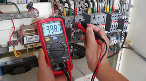 UNI-T UT136B+ Auto-Range Digital Multimeter – 4000 Count, AC/DC 1000V, 10A, Capacitance 40mF, Frequency, Temperature, hFE, Diode, 2m Drop-Proof - in a red casing being used to measure electrical voltage, showing 398.0 AC on its display with red and black probes.