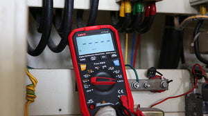 UNI-T UT161E True RMS Digital Multimeter – 22000 Count, AC/DC 1000V, 20A, High Accuracy 0.05%, 220MHz Frequency, Temperature, NCV, USB, CAT III 1000V - in a red protective case, showing a blank screen with NCV indicator, a central rotary dial, and buttons in an electrical panel.