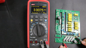 UNI-T UT171C Industrial True RMS Digital Multimeter – 60000 Count OLED, AC/DC 1000V, 10A, LoZ, Square-Wave Output, -30°C Rated, USB & Bluetooth, CAT III 1000V - with a red casing, OLED display showing 3.0075 MΩ, and probes testing a green circuit board.