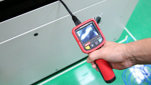 UNI-T UT665 Industrial Borescope – 2.4" TFT Screen, 9mm Camera Probe, 1m Semi-Rigid, IP67, 4 LED, Inspection Endoscope Camera - held in a hand, showing a red handle, a 2.4-inch display with a live camera feed, and a black semi-rigid probe.