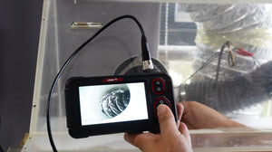 UNI-T UT667-10M Industrial Borescope – 4.3" IPS Screen, 8mm Lens, 10 m Replaceable Probe, IP67, 8 LED, Inspection Endoscope Camera - a live view of a pipe interior on its 4.3-inch screen with visible control buttons.