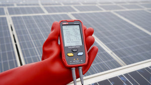 UNI-T UT673PV Solar MPPT Power Meter – 5–800W, 12–60V, 0–35A, Manual/Auto MPPT Test, Solar-Panel Powered, PV Output Tester - held in a red-gloved hand, showing a digital display with 16.4W, 206V, 0.8A, 326V, and 1.7A readings against solar panels.