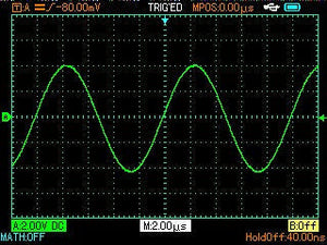UNI-T UTD1102C 100 MHz 2-Channel Handheld Oscilloscope – 7.5 Kpts, 500MSA/S - screen displaying a green sine wave signal on a black grid background with measurement settings at the bottom.