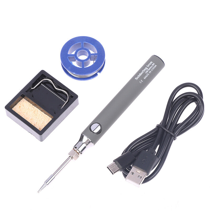USB Soldering Iron Portable 8W Type C price - shown with a grey pen-style iron, a metal stand with a cleaning sponge, a spool of solder, and a USB charging cable.