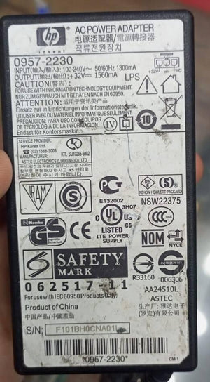 Used 32V Adapter Power Supply With 220V Power Cable - a rectangular black power brick showing a detailed technical specification label with HP branding and various safety symbols.