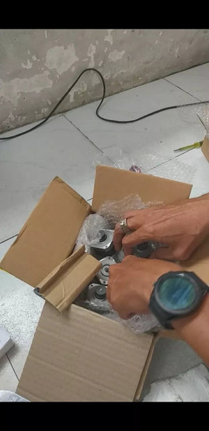 Used 4 Wire NEMA 17 5mm Shaft Bipolar Stepper Motors - shown inside a cardboard shipping box with bubble wrap, being handled by a person.