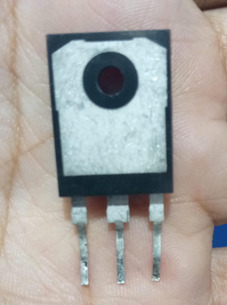 Used K75T60 IGBT - 600V 75A High-Power IGBT - a black and silver three-pin electronic component held in a palm.