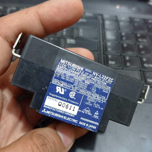 Used Mitsubishi NV-L22FZC 24A Earth Leakage Circuit Breaker Switch - a black rectangular electrical component held in a hand, showing its technical specification label.