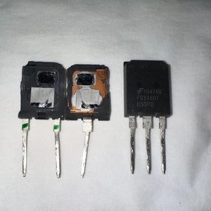 USED Onsemi 160A 650V FGY160T65SPD Onsemi IGBT-Digilog.pk - two damaged units with exposed internal components next to one intact black three-pin transistor.