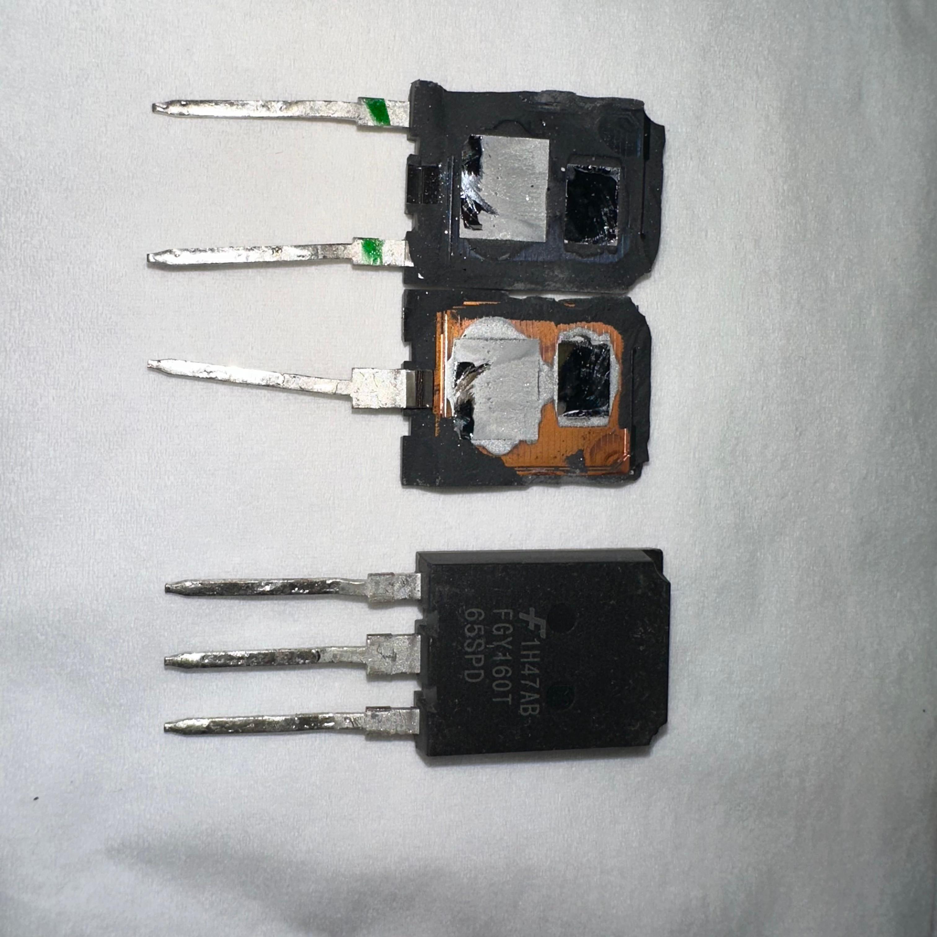 USED Onsemi 160A 650V FGY160T65SPD Onsemi IGBT-Digilog.pk - two damaged units with exposed internal components next to one intact black three-pin transistor.