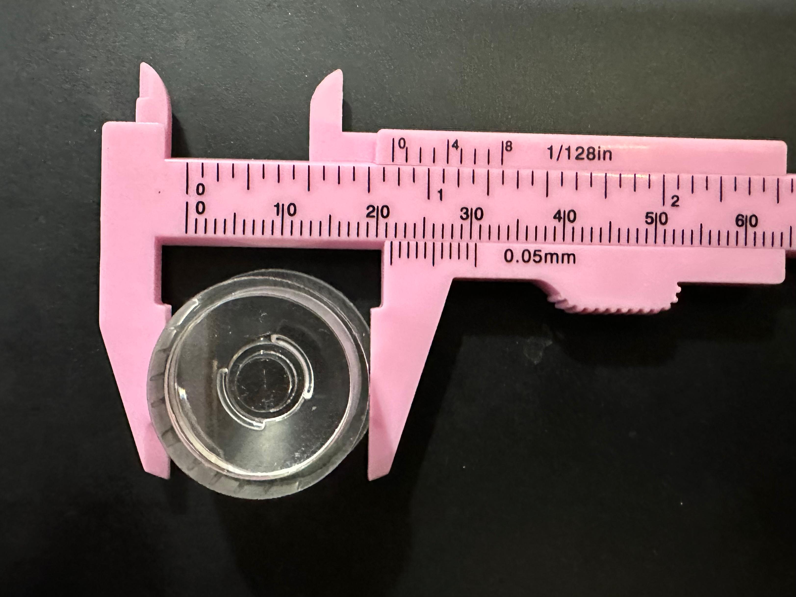 Versatile Waterproof LED Lens 1W/3W 20mm Diameter Smooth surface 15°/30° Beam Options - shown in a close-up top-down view being measured by a pink plastic vernier caliper.