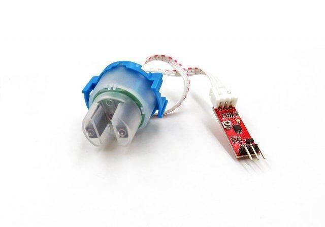 Water Turbidity Sensor - a blue and translucent plastic sensor head connected by a white ribbon cable to a small red circuit board with three pins.