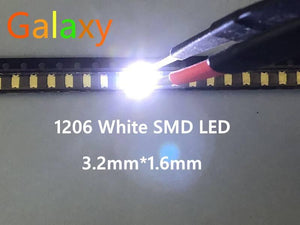 White SMD 1206 LED Super Bright Light Emitting Diode - a single small rectangular white light emitting diode illuminated on a reel and being held by a pair of tweezers.