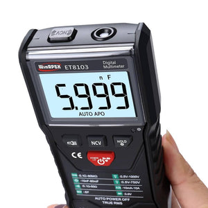 Winapex ET8103 LCD Auto Measure Digital Multimeter 6000 Counts - its LCD screen displaying 5.999 nF, control buttons, and NCV sensor held in a hand.